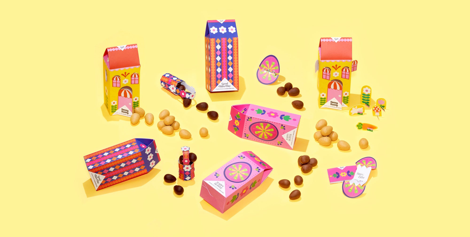 Colourful packaging design for a collection of chocolate bars, photographed against a yellow background and featuring folk art-inspired papercraft collage illustration in various Easter-themed motifs.