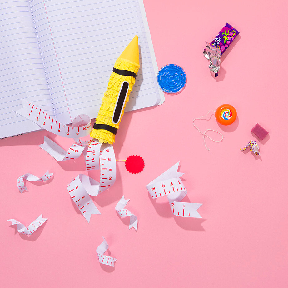 Spread from Kitiya Palaskas' Pinata Party book featuring a yellow pencil pinata