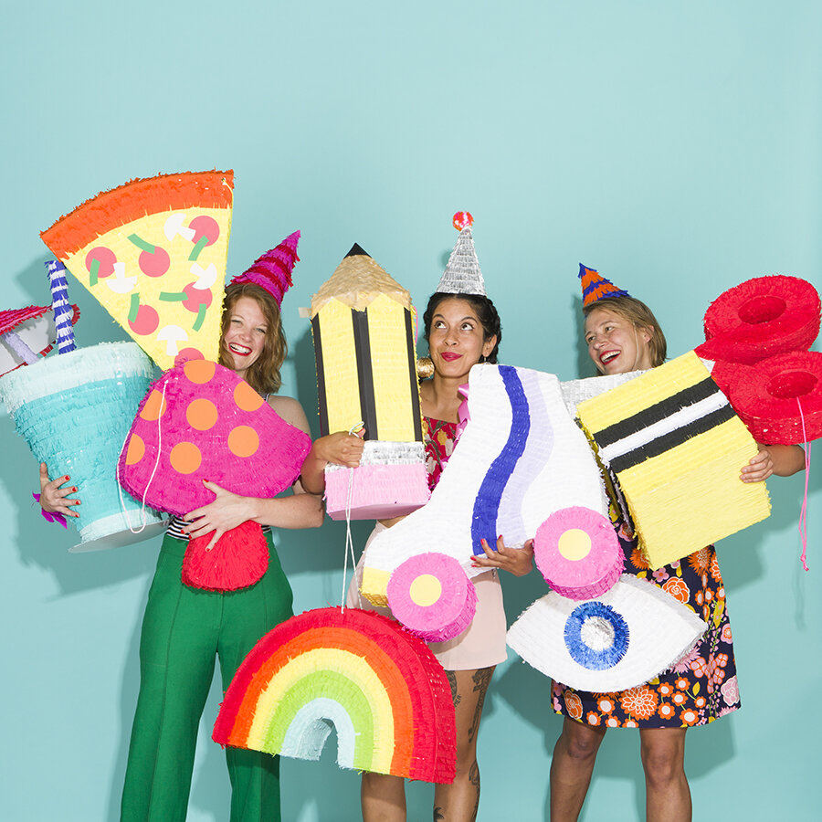 Spread from Kitiya Palaskas' Pinata Party book featuring  group of people with pinatas