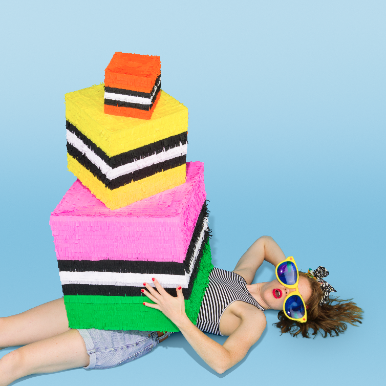 Spread from Kitiya Palaskas' Pinata Party book featuring a stack of liquorice allsorts pinatas